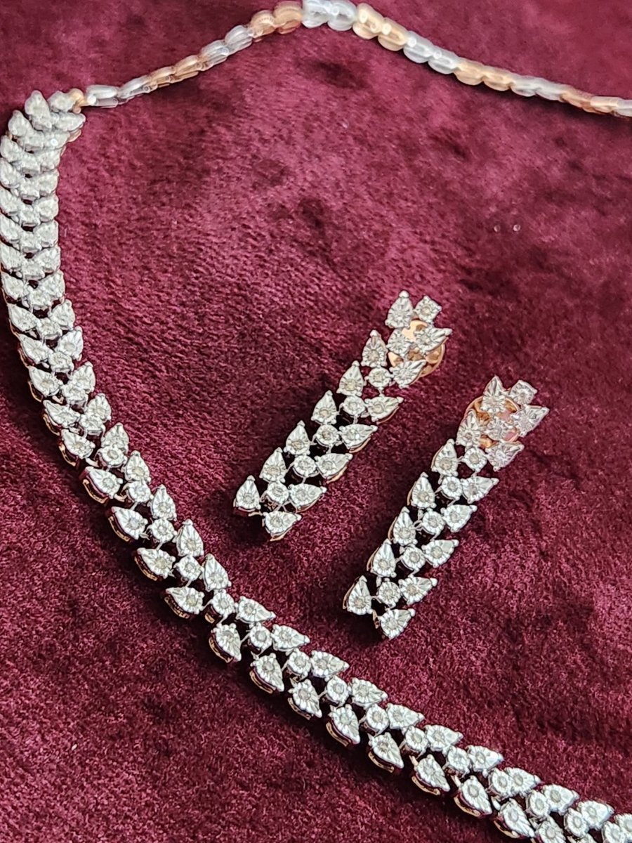 Diamond necklace and earrings on maroon velvet