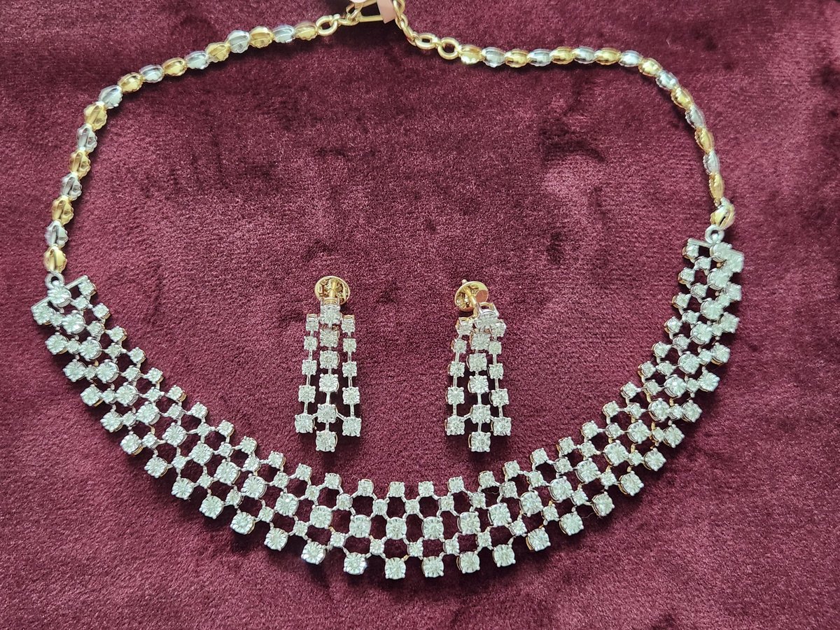 Diamond necklace set with matching earrings on maroon velvet